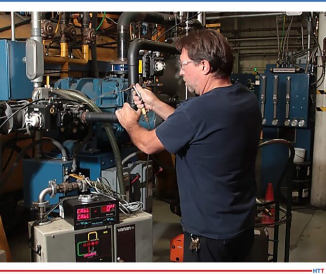A man running tests on the furnace in front of him