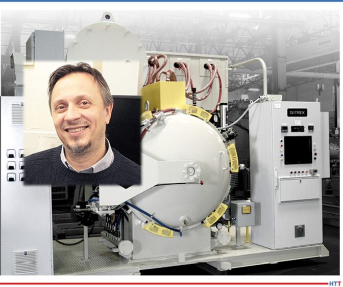 Grey vacuum furnace with yellow parts surrounding it