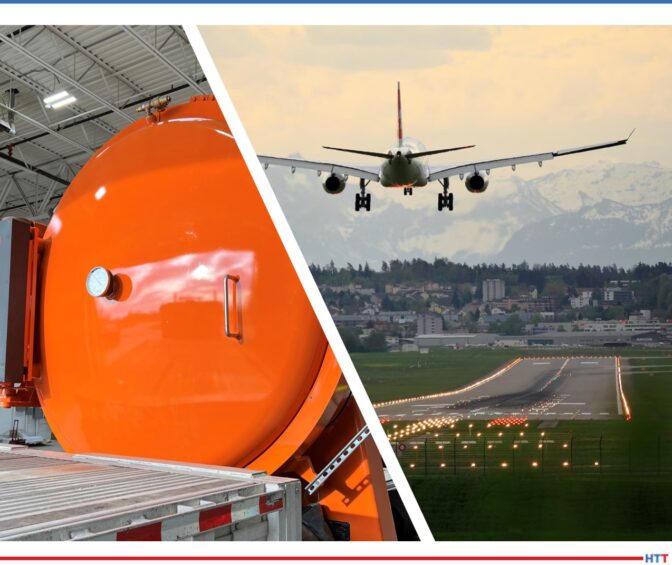 Bright orange vacuum furnace with a background picture of an airplane coming in for a landing.