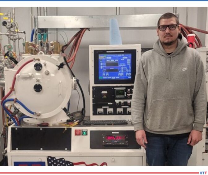 a heat treat furnace and a young man standing next to it
