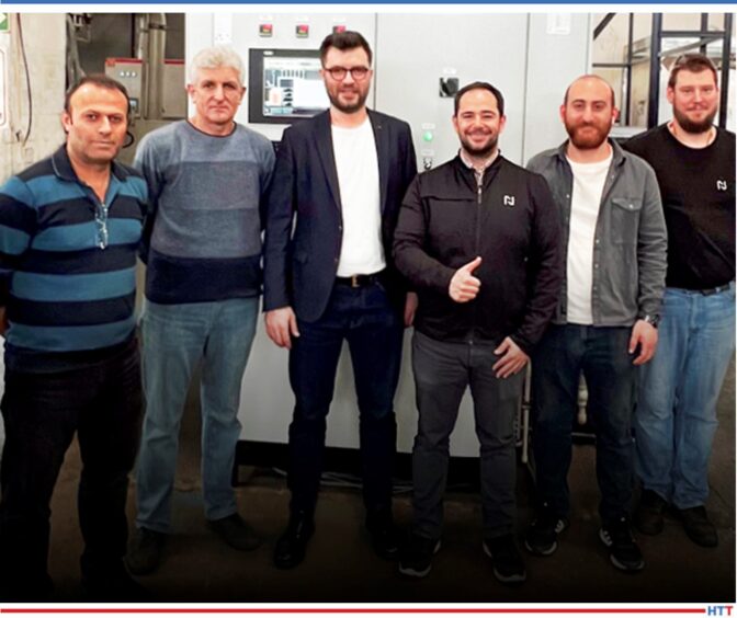 men in front of pit furnace