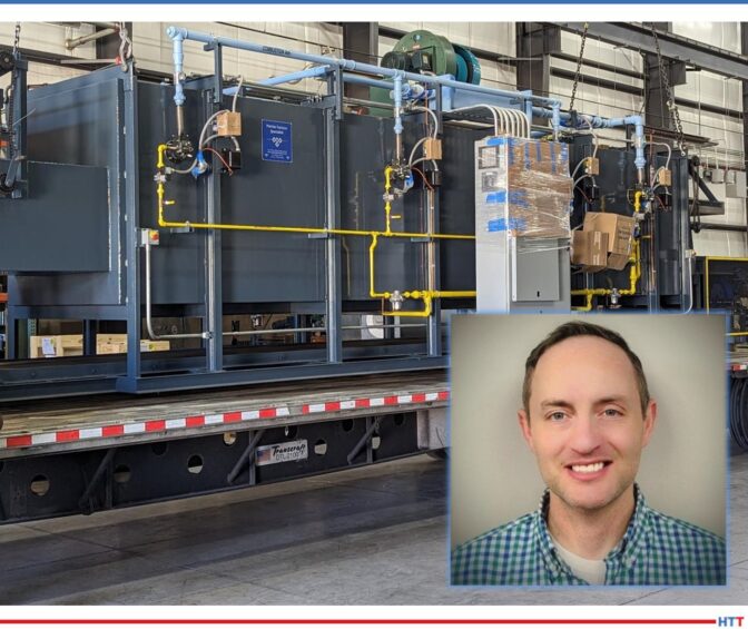 large, blue/grey heat treat furnace loaded onto a flatbed truck