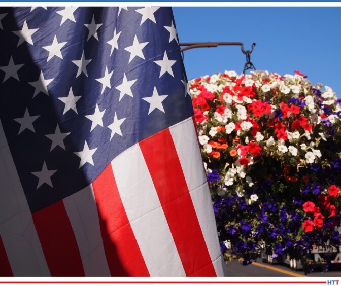 American flag and a potted plant with flowers of red, white, and blue